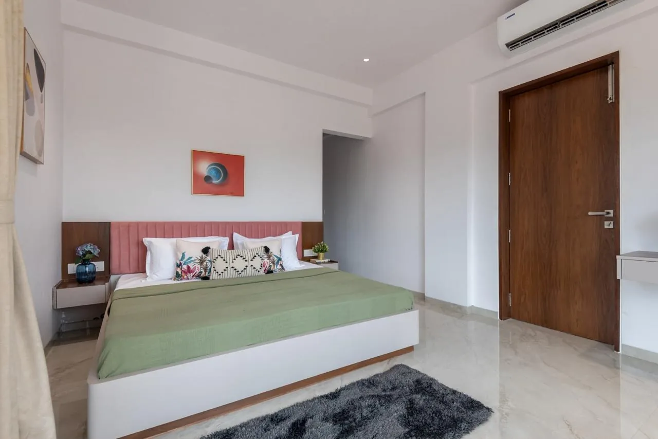 A bedroom with a rose headboard