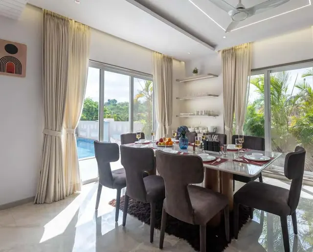 The dining table, the pool through the glass